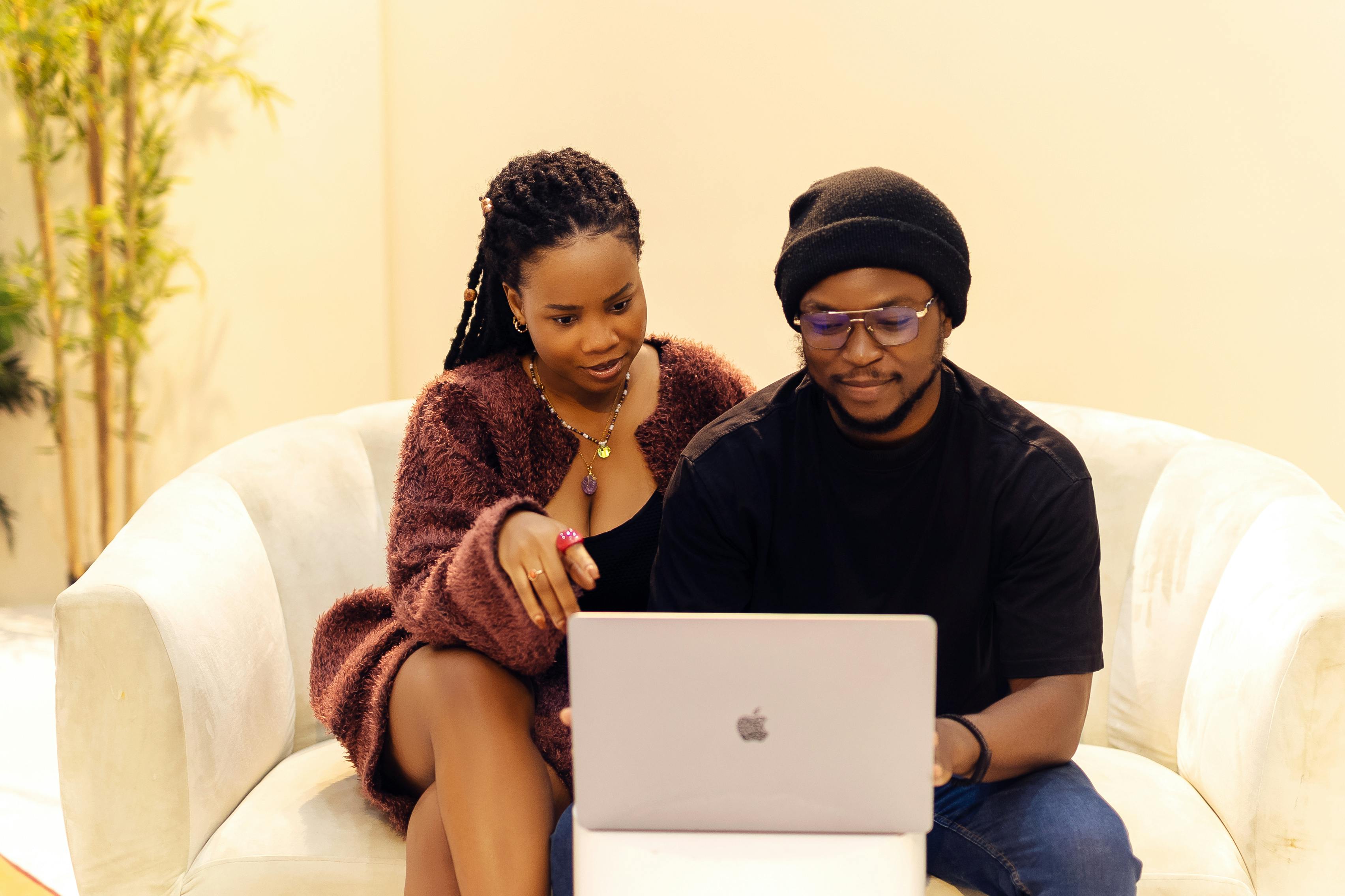 Two professionals in Lagos reviewing options together on a laptop